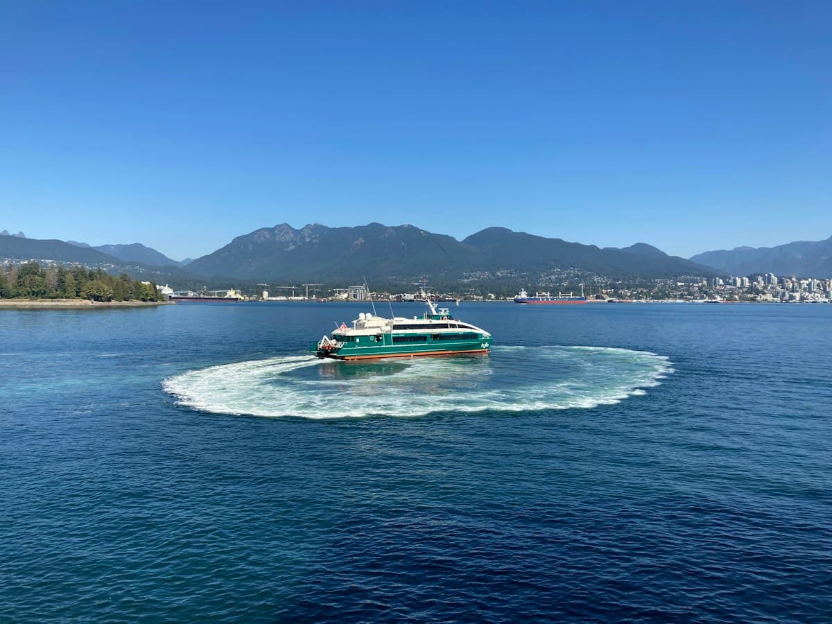 Sightseeing boat on Vancouver Harbour with mountains beyond